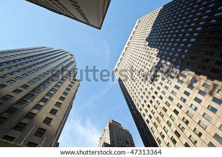 Looking up toward the sky among tall skyscrapers.