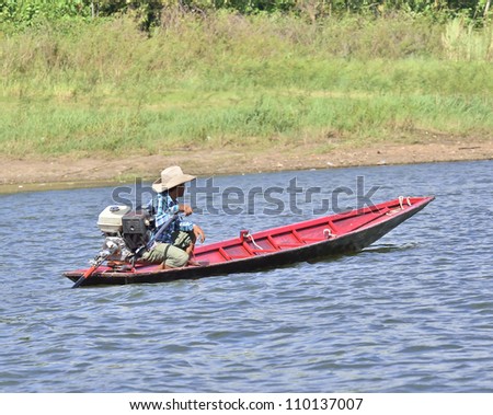 man driving fishing boat in lake