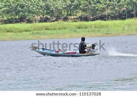 man driving fishing boat in lake
