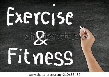 hand writing word Exercise and Fitness with chalk on blackboard