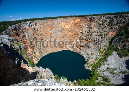 IMOTSKI, CROATIA - April 24, 2013 - Red lake in Imotski, Croatia is a limestone crater, with it\'s cliffs 200 m high and lake 300 m deep.