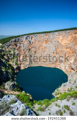 IMOTSKI, CROATIA - April 24, 2013 - Red lake in Imotski, Croatia is a limestone crater, with it\'s cliffs 200 m high and lake 300 m deep.
