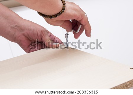 A carpenter builds a wooden closet