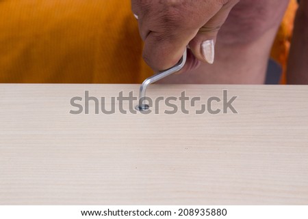 A carpenter builds a wooden closet