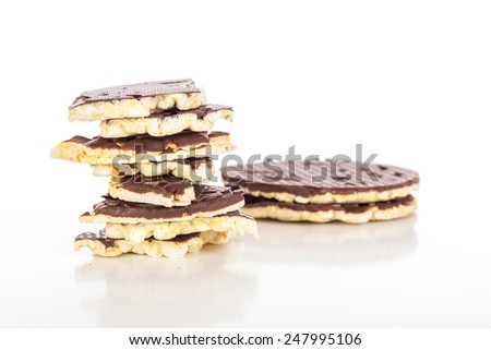 Pieces of chocolate coated rice cakes on white background