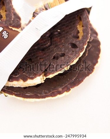A stack of chocolate coated rice cakes on white background