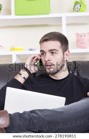 Boy phoning and using a computer