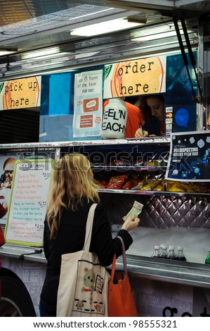 AUSTIN - MARCH 26: An unidentified patron stops to buy food from a local trailer food spot near a SXSW event on March 26, 2012 in Austin, Texas.