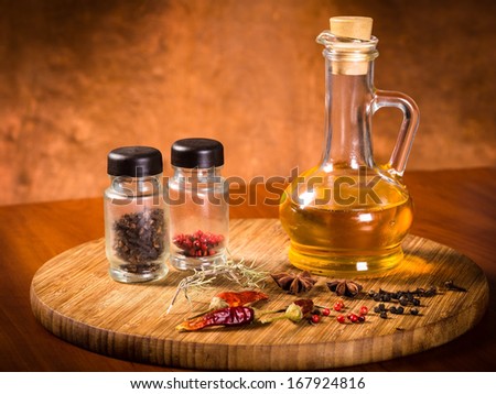 oil, pepper and spices on a cutting board