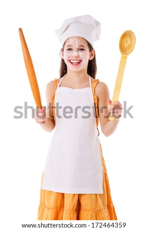 Smiling chef girl with ladle and rolling pin, isolated on white