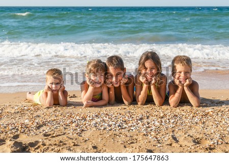 Five smiling kids enjoying on the beach Five smiling kids enjoying on the beach
