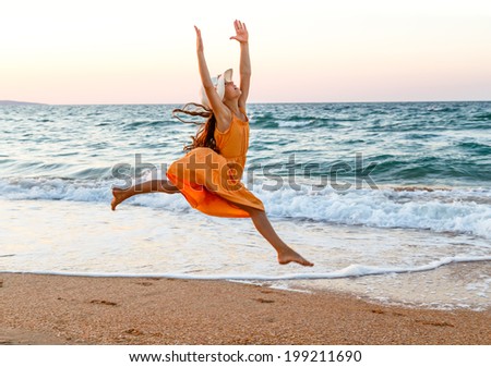 Girl running on beach along the surf