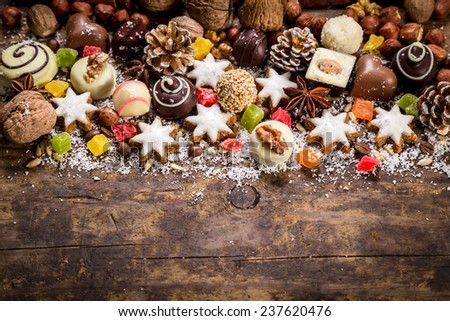 Wood background with sweets, candies, nuts, cookies and dried fruits