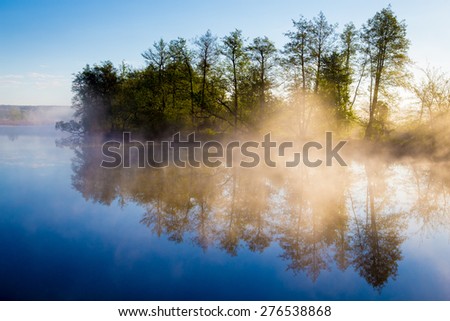 Morning fog on a calm river, tranquil scene. Vorskla river, Ukraine