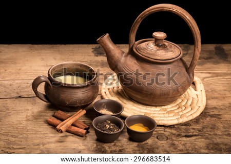 Masala tea with spices on dark wooden table