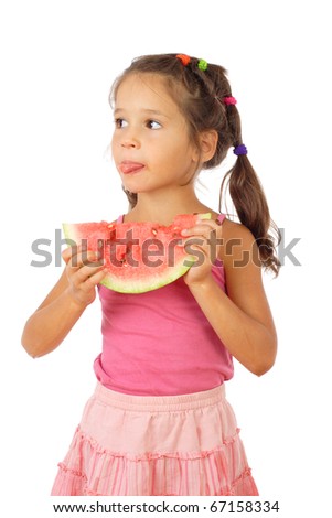 Little girl eating watermelon, sticking out tongue, studio shoot