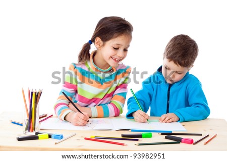 Two little kids at the table draw with crayons isolated on white Two little kids at the table draw with crayons isolated on white