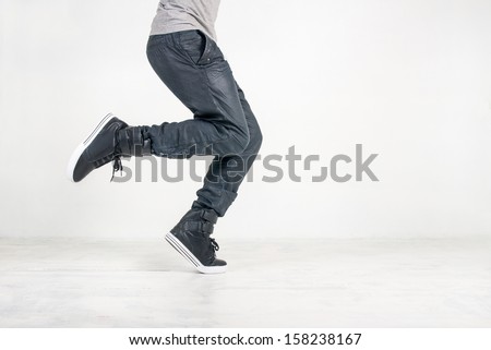 street dance in jeans and sneakers on white background