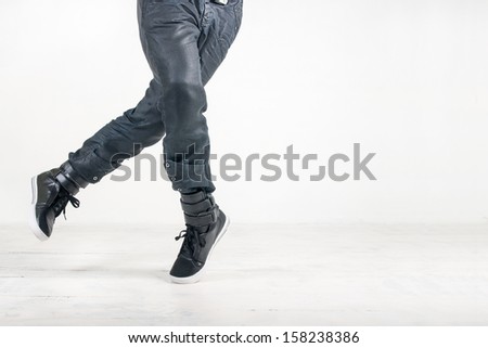 street dance in jeans and sneakers on white background