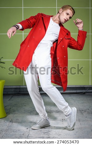 stylish guy in red trench coat with gold haircut