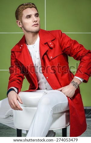 stylish guy in red trench coat with gold haircut