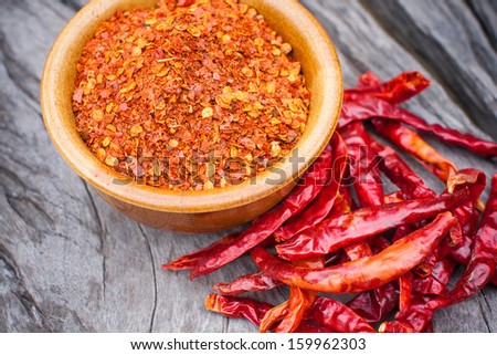 Hot red chili peppers and red pepper on wood