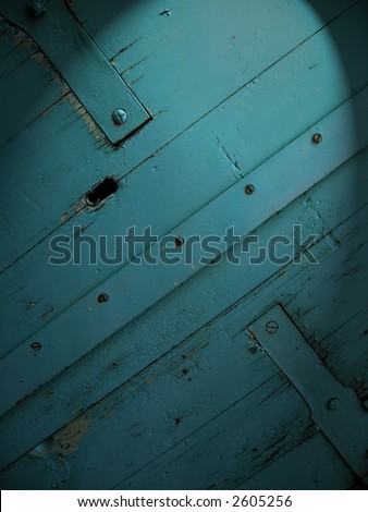 Old dark wooden door digitally enhanced to look like it\'s spotlighted at night. For background use.