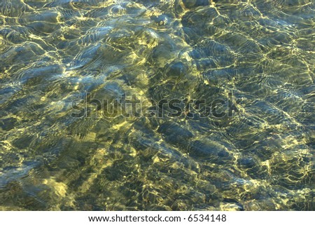 Early morning sun, blue sky and water motion create a luminous background texture.