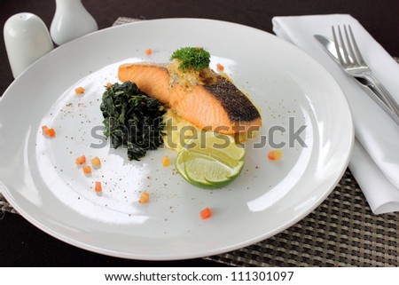 Salmon steak with sauce and boiled vegetables
