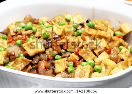 Close up on fried tofu with vegetables