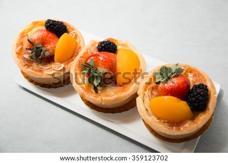 Fresh dessert fruit tart covered in assorted tropical fruits