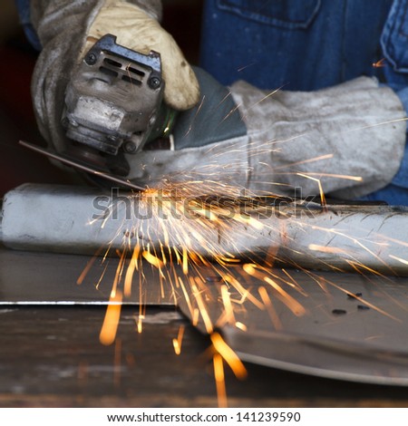 worker grinding steel