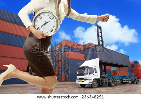 Woman holding a clock in a hurry with the delivery of Business for shipping on time.