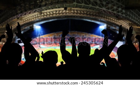 Football, soccer fans support their team and celebrate goal, score, victory. Full stadium
