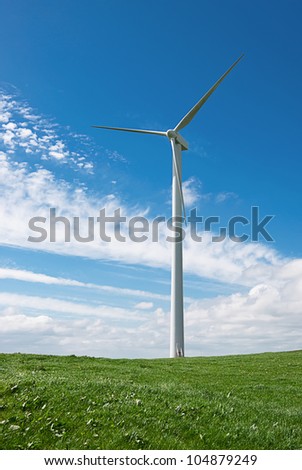 Beautiful  green meadow with wind turbines generating electricity