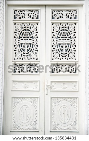 A modern single wooden door painted in white
