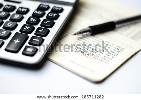 Calculations and account book and pen