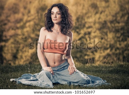 young brunet woman at forest grass