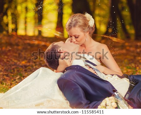 wedding couple kissing at fall season forest