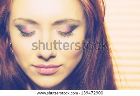 young pretty woman\'s face with makeup closeup