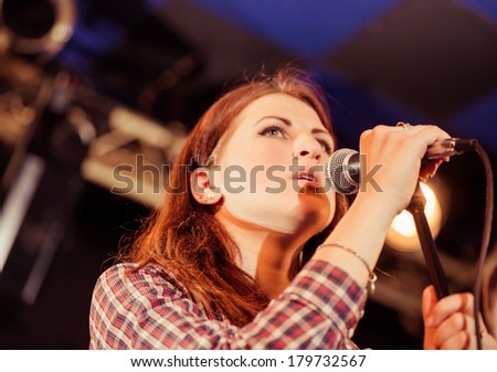 young woman singing on a stage