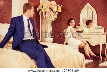 bride and groom at bedroom interior