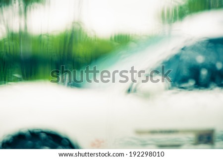 car behind rainy glass