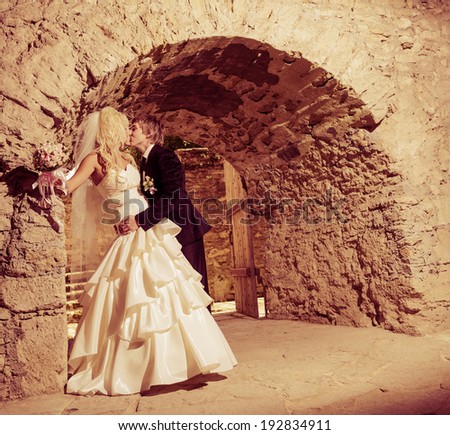 young wedding couple at old mansion entrance