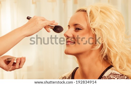 makeup artist making face correction
