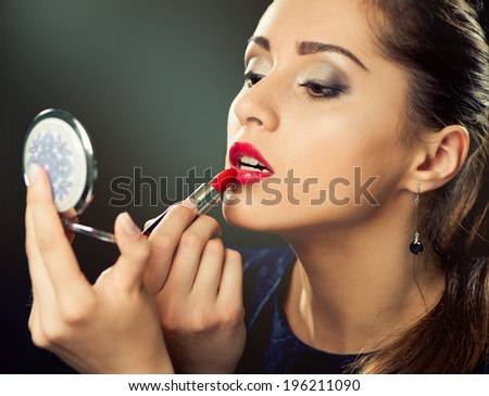 young sexy woman making makeup with lipstick