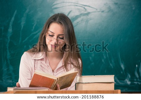 pretty teacher reading open book