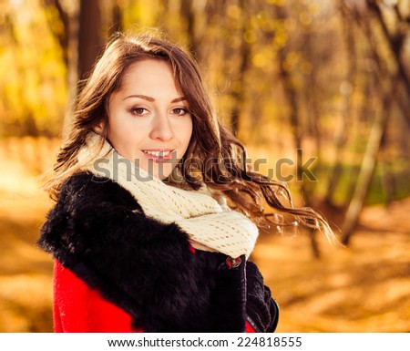 pretty young brunet portrait at fall nature background