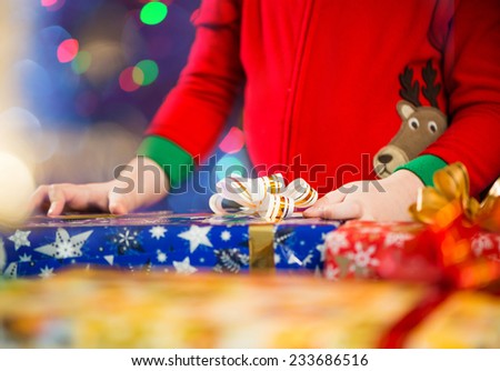 little boy arms on a christmas gift boxes