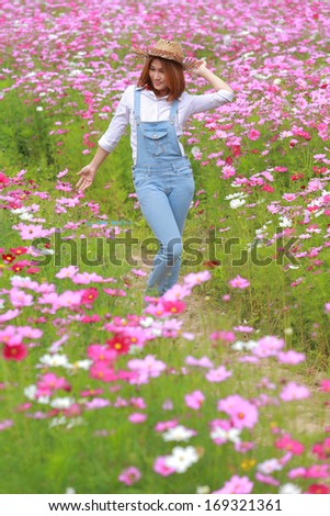 Portrait woman Agriculture in cosmos flower field the garden